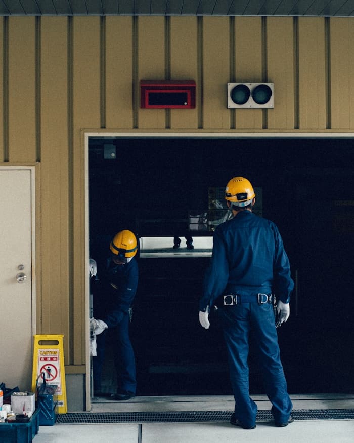 Professional garage door technician assisting a homeowner
