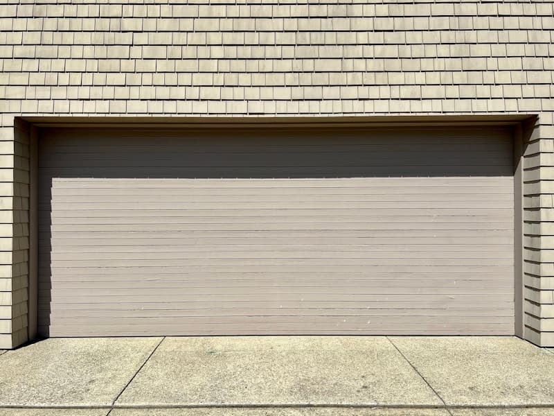 Damaged garage door requiring immediate repair